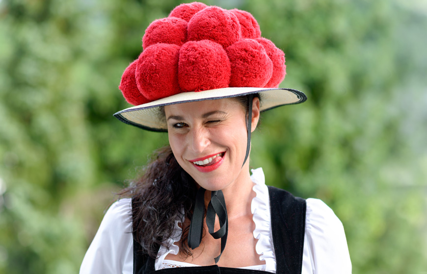 Beautiful winking german woman wearing bollenhut